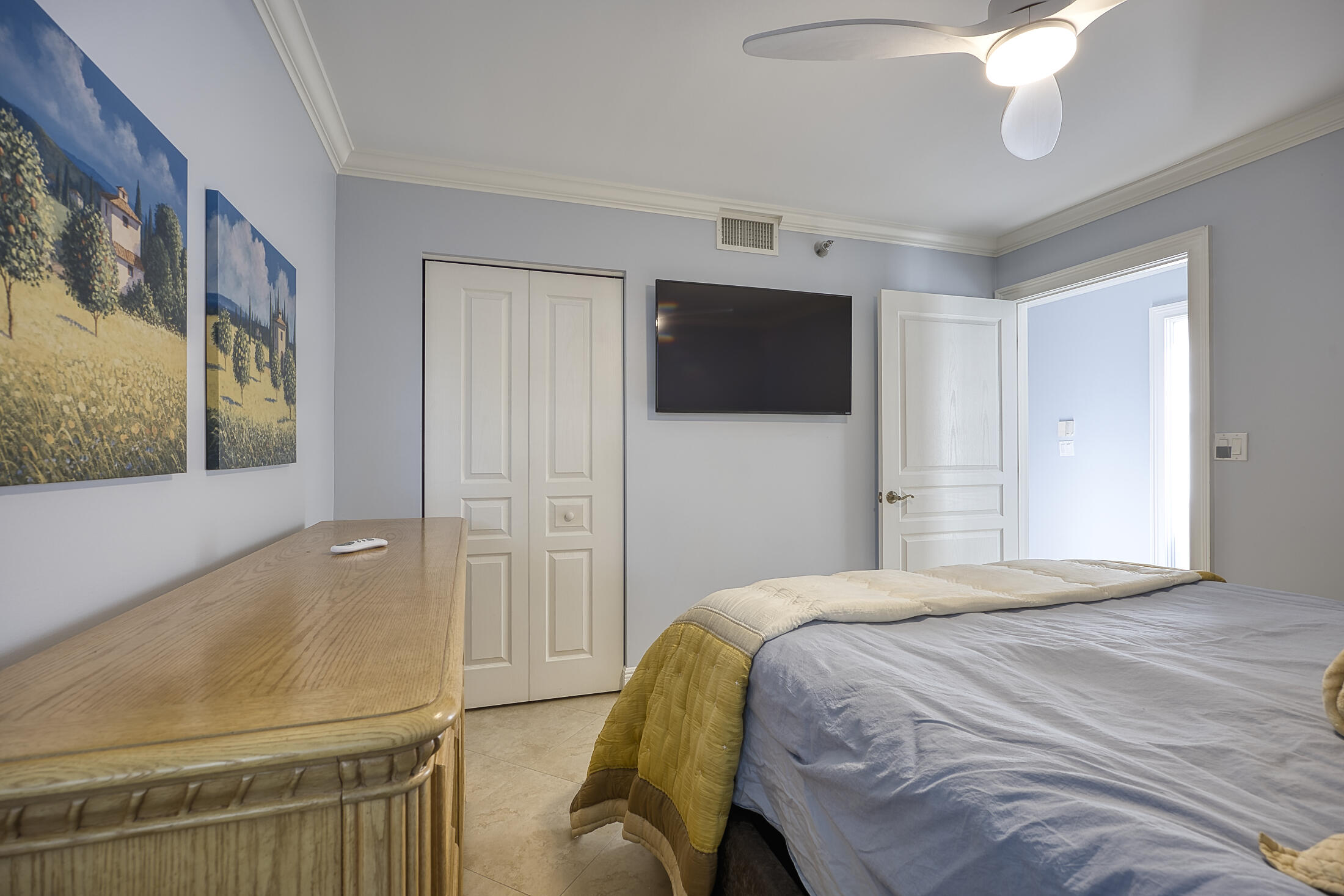 380 Northwest 67th Street, Unit 101 Boca Raton, FL 33487 - Photo 28 of 44 a bedroom with a bed and a flat screen tv