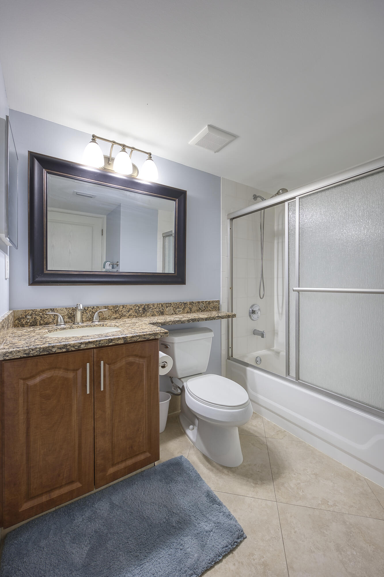 380 Northwest 67th Street, Unit 101 Boca Raton, FL 33487 - Photo 29 of 44 a bathroom with a toilet sink and mirror