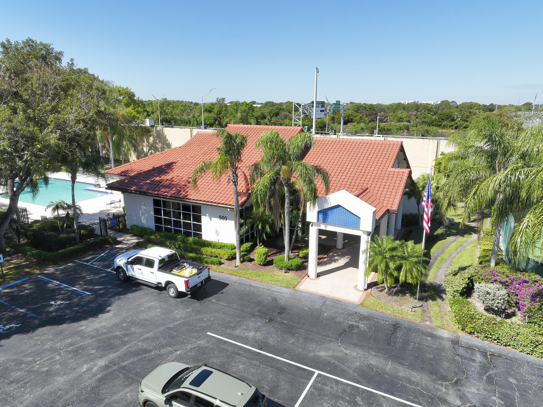 380 Northwest 67th Street, Unit 101 Boca Raton, FL 33487 - Photo 34 of 44 a front view of a house with a yard and garage