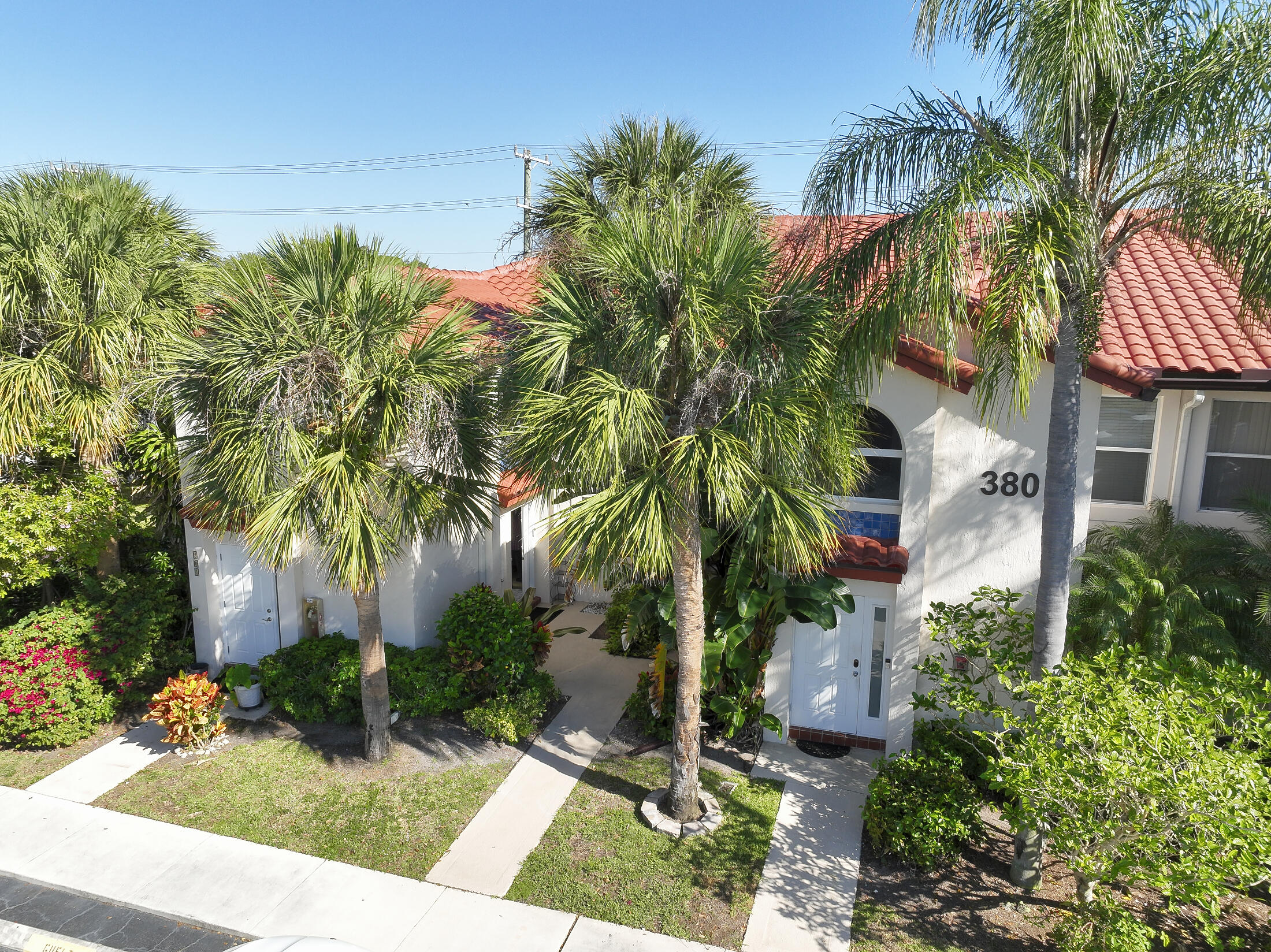 380 Northwest 67th Street, Unit 101 Boca Raton, FL 33487 - Photo 43 of 44 a plant that is in front of a house