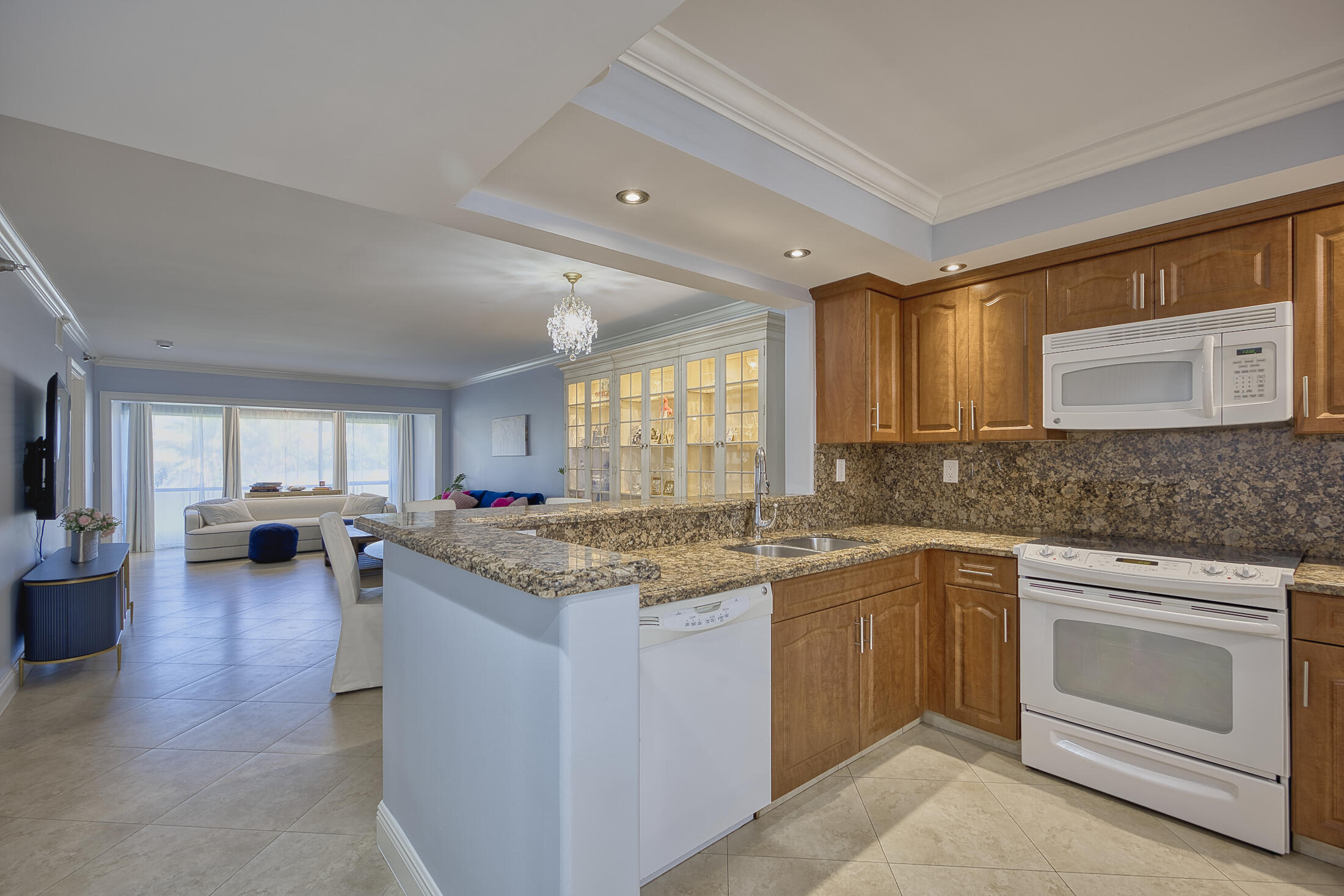 380 Northwest 67th Street, Unit 101 Boca Raton, FL 33487 - Photo 5 of 44 a kitchen with a stove top oven sink and cabinets