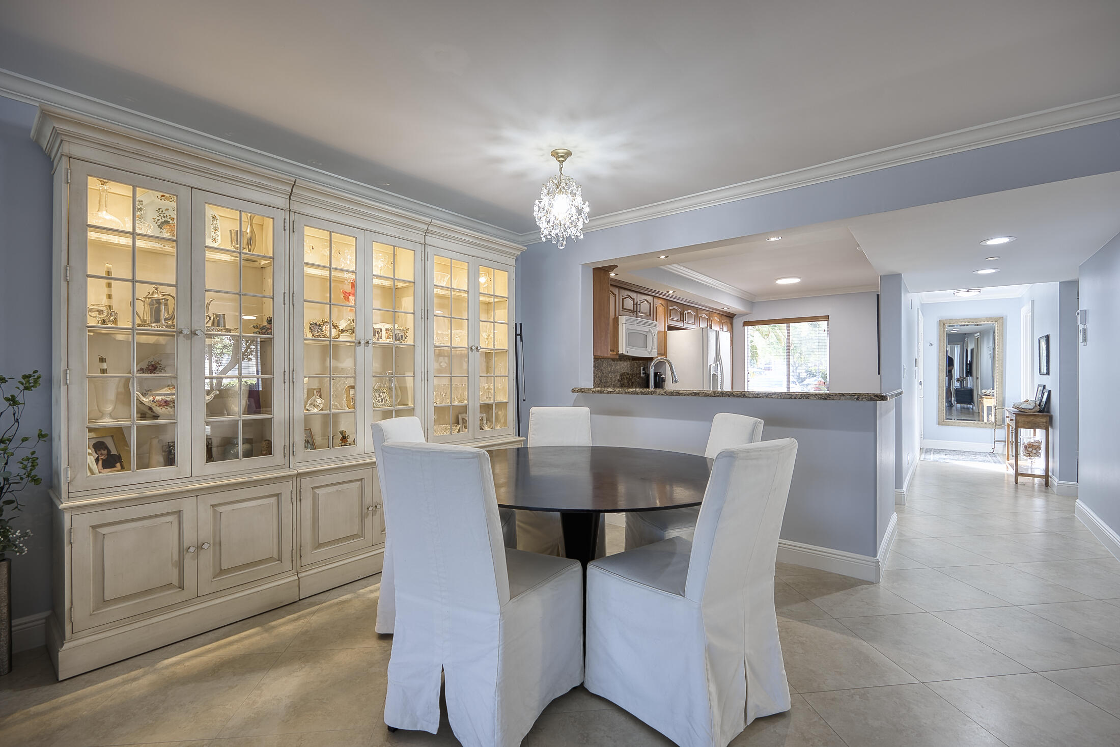 380 Northwest 67th Street, Unit 101 Boca Raton, FL 33487 - Photo 6 of 44 a dining room with furniture a chandelier and wooden floor
