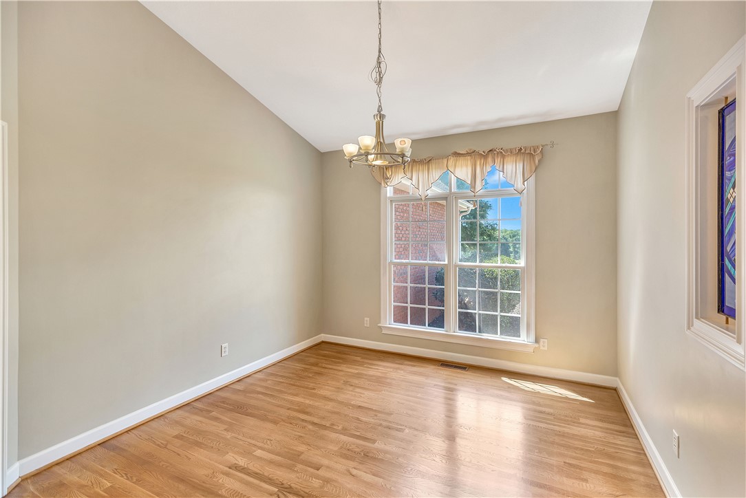 3620 Centerville Road Anderson, SC 29625 - Photo 22 of 49 Hardwood floors and vaulted ceilings frame a bright space centered around a classic chandelier.