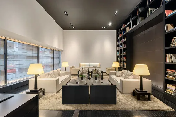 a living room with furniture and a lamp
