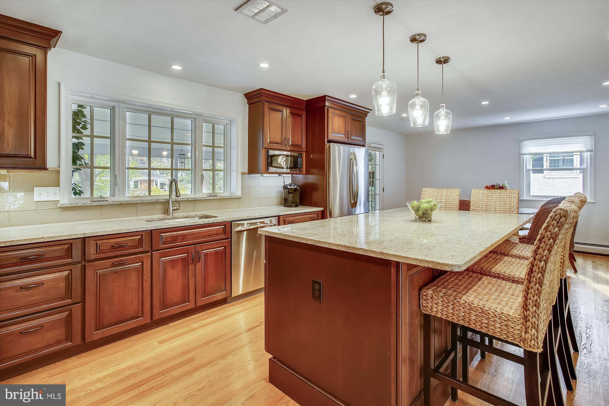 1437 Cola Drive McLean, VA 22101 - Photo 4 of 34 a kitchen with granite countertop cabinets table and stainless steel appliances
