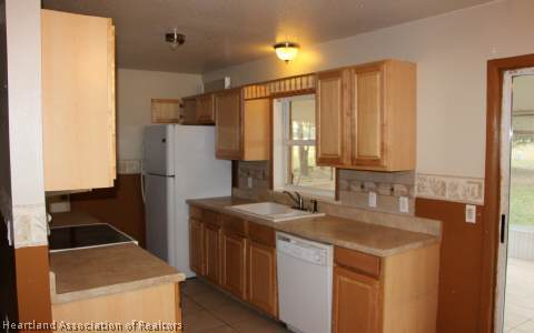 208 Mirador Drive Sebring, FL 33876 - Photo 14 of 17 a kitchen with a sink stove and refrigerator