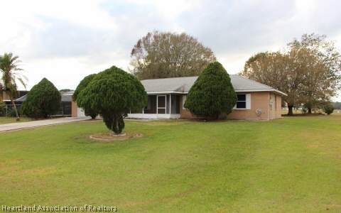 208 Mirador Drive Sebring, FL 33876 - Photo 16 of 17 a view of a house with a yard and garage