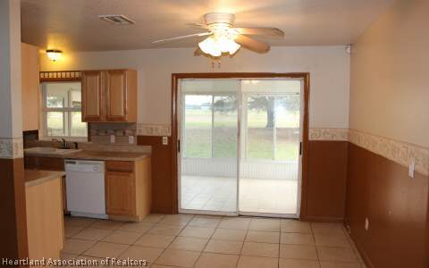 208 Mirador Drive Sebring, FL 33876 - Photo 4 of 17 a kitchen with granite countertop a refrigerator a sink and dishwasher