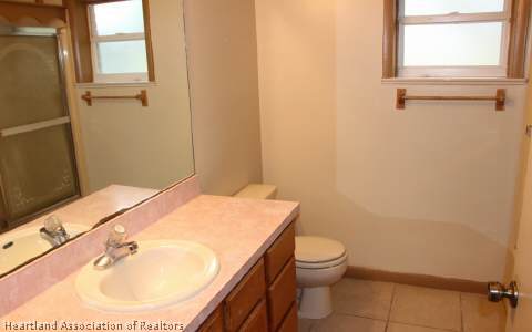 208 Mirador Drive Sebring, FL 33876 - Photo 8 of 17 a bathroom with a sink a toilet and a mirror
