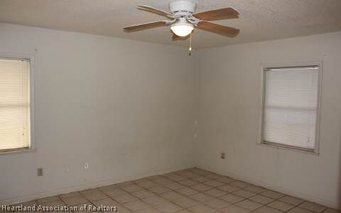 208 Mirador Drive Sebring, FL 33876 - Photo 9 of 17 an empty room with a window and a fan
