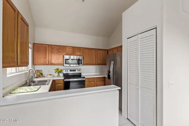 a kitchen with kitchen island a stove a sink and a refrigerator