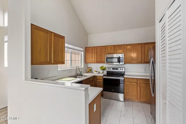 a kitchen with a sink stove and refrigerator