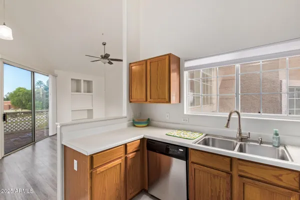 a kitchen with a sink cabinets and window