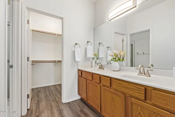 a bathroom with a double vanity sink and mirror