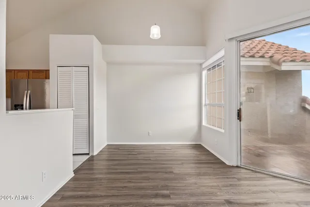 a view of a hallway with wooden floor and entryway