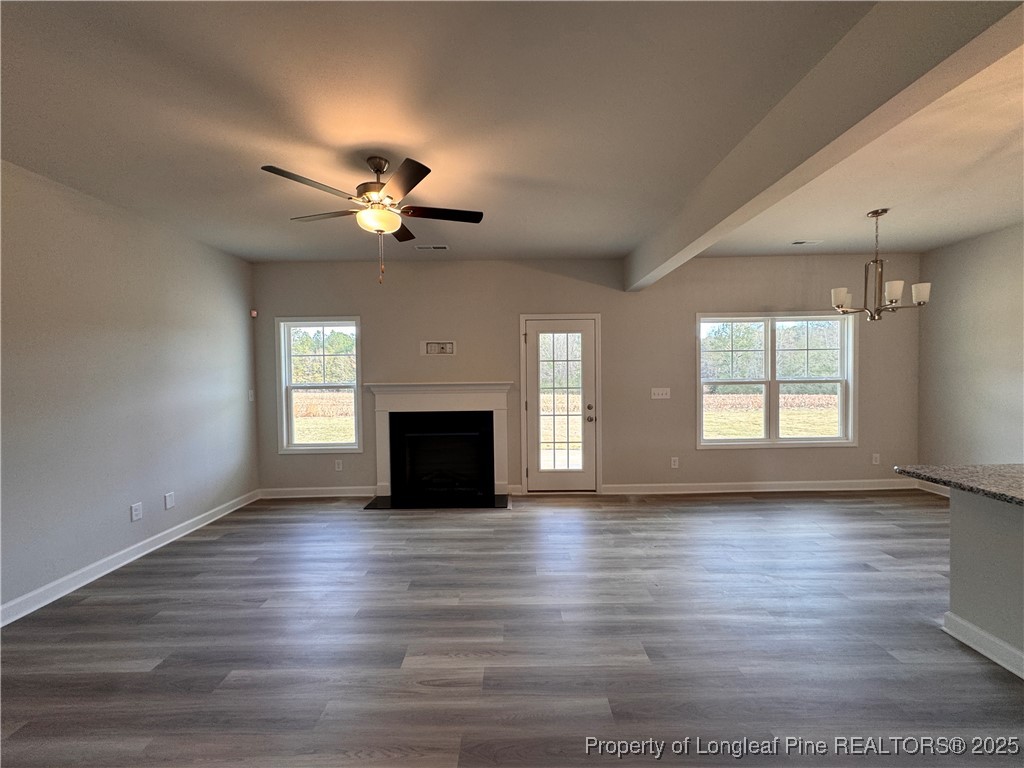 294 Elijah Way Vass, NC 28394 - Photo 11 of 33 a view of empty room with wooden floor and fan