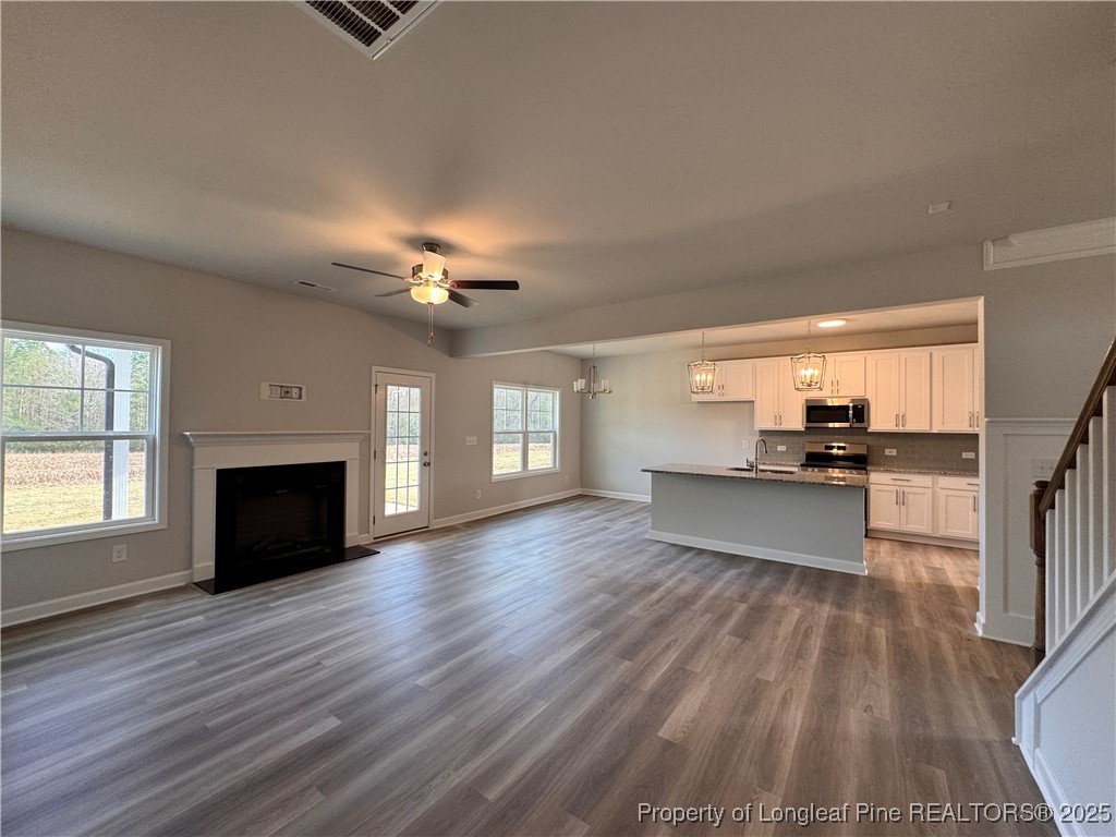 294 Elijah Way Vass, NC 28394 - Photo 14 of 33 a view of a living room a fireplace with windows and a fireplace