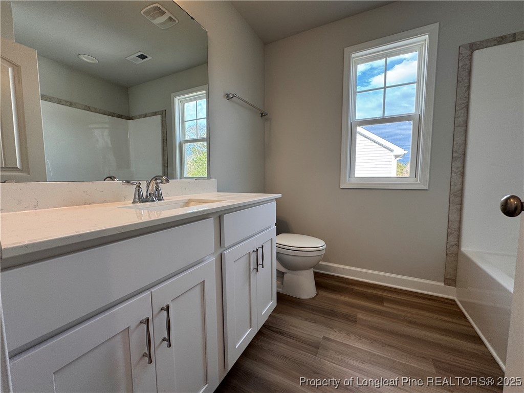294 Elijah Way Vass, NC 28394 - Photo 21 of 33 a spacious bathroom with a double vanity sink toilet and a mirror