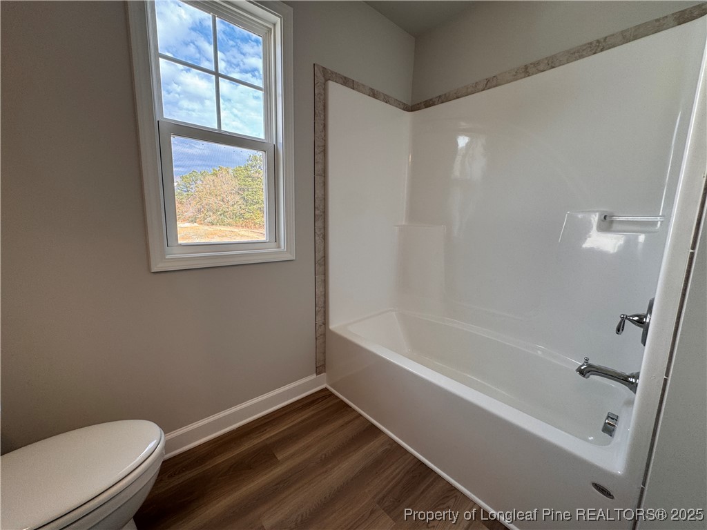294 Elijah Way Vass, NC 28394 - Photo 22 of 33 a bathroom with a bathtub and window