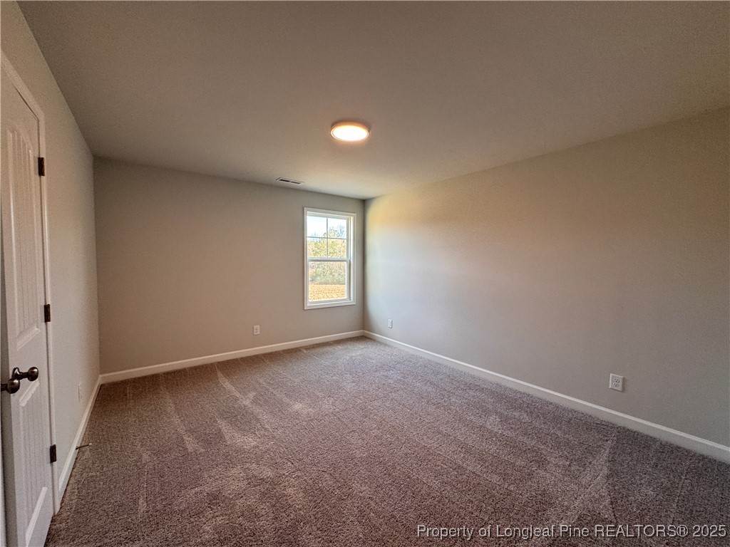 294 Elijah Way Vass, NC 28394 - Photo 26 of 33 an empty room with windows and closet