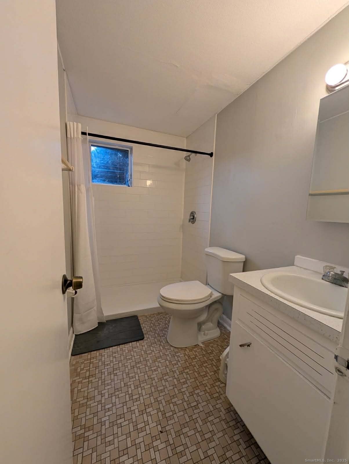 114 South Washington Street, Unit 24 Plainville, CT 06062 - Photo 11 of 14 a bathroom with a granite countertop toilet and a sink