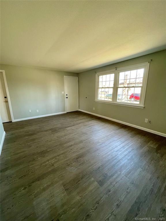 114 South Washington Street, Unit 24 Plainville, CT 06062 - Photo 4 of 14 an empty room with wooden floor and windows