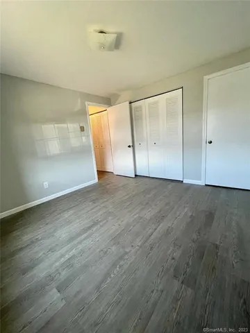 a bathroom with a granite countertop toilet and a sink