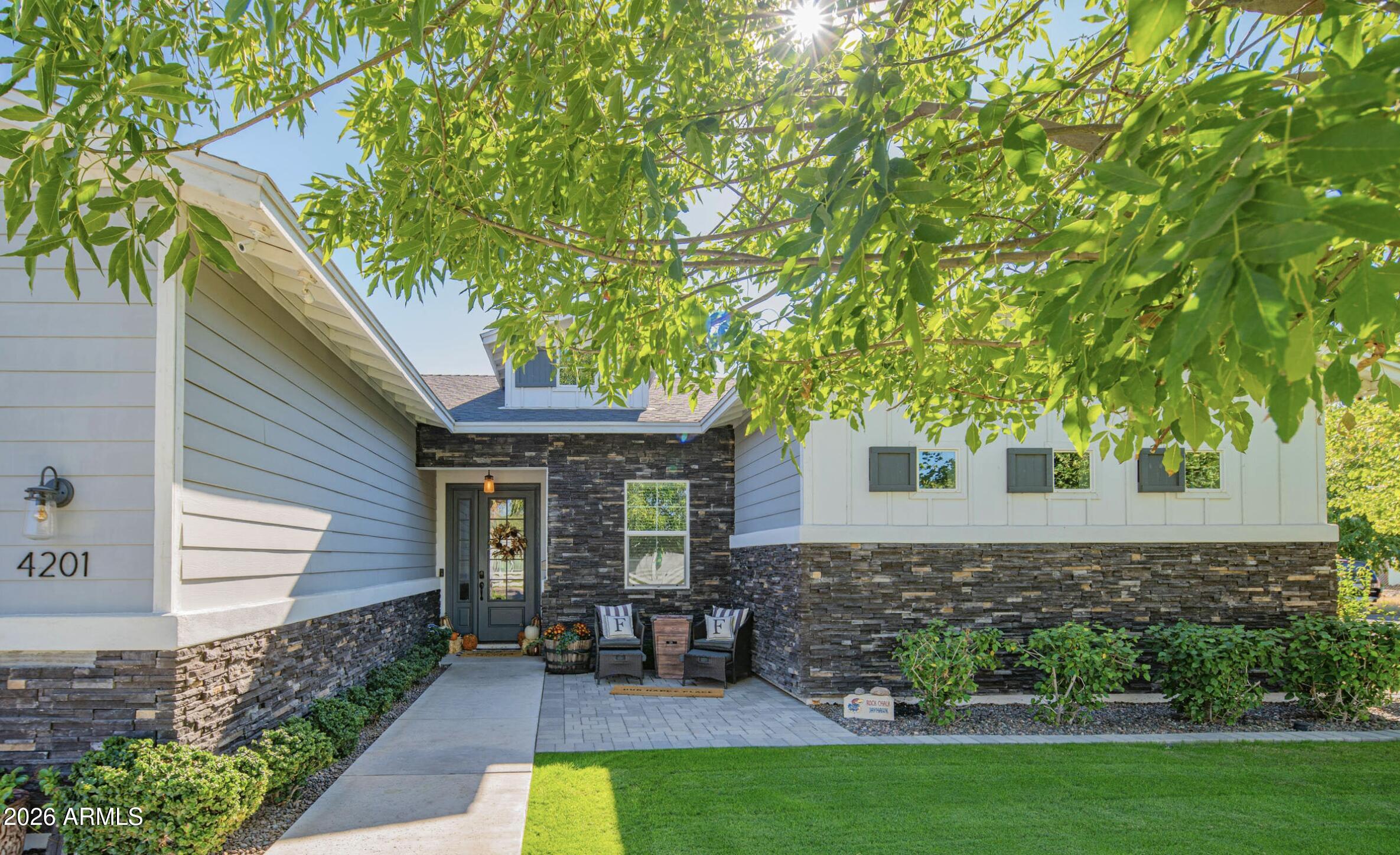 a view of house with a backyard
