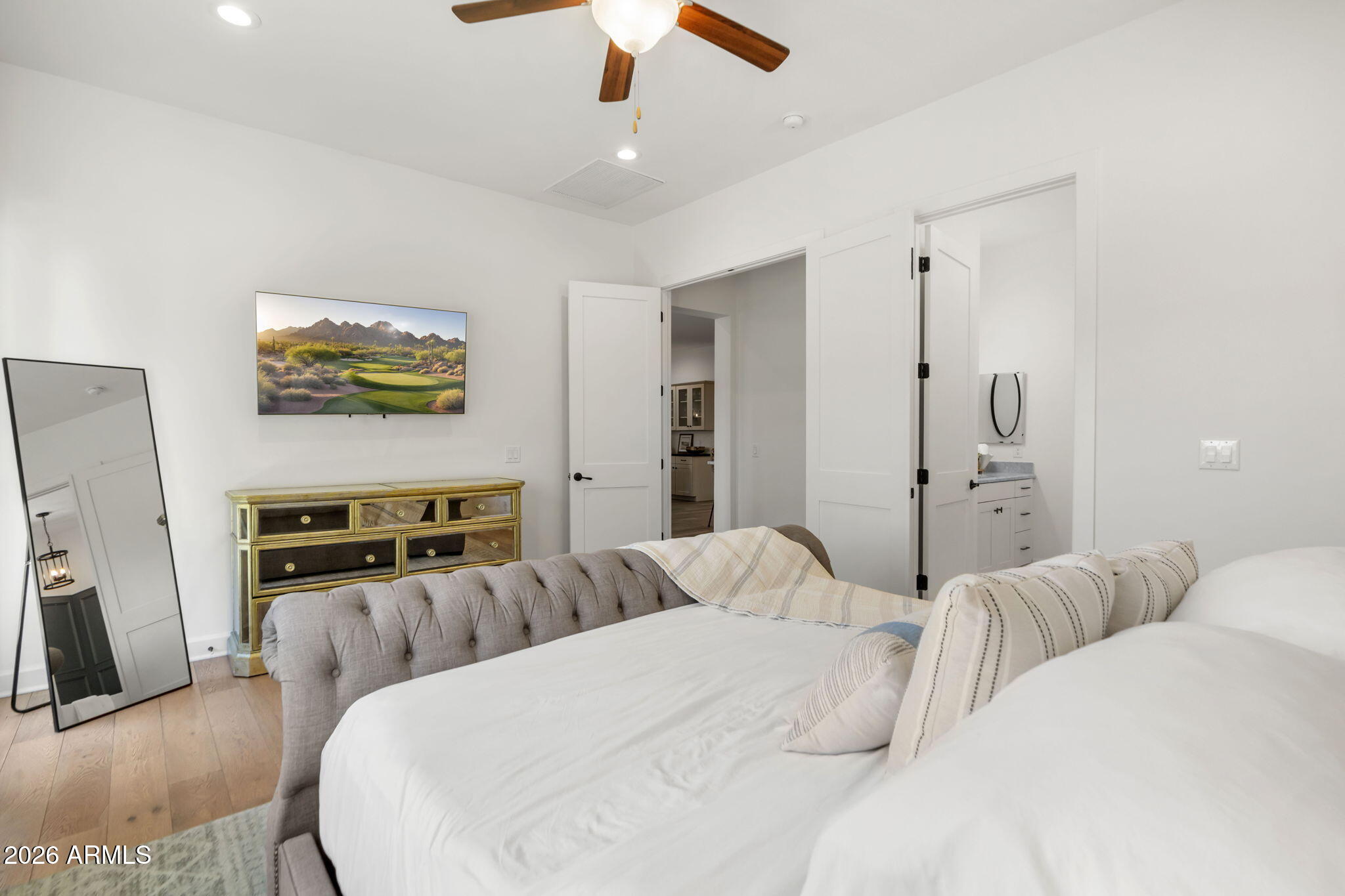 4201 East Cheery Lynn Road Phoenix, AZ 85018 - Photo 12 of 31 a bedroom with a bed and a chandelier