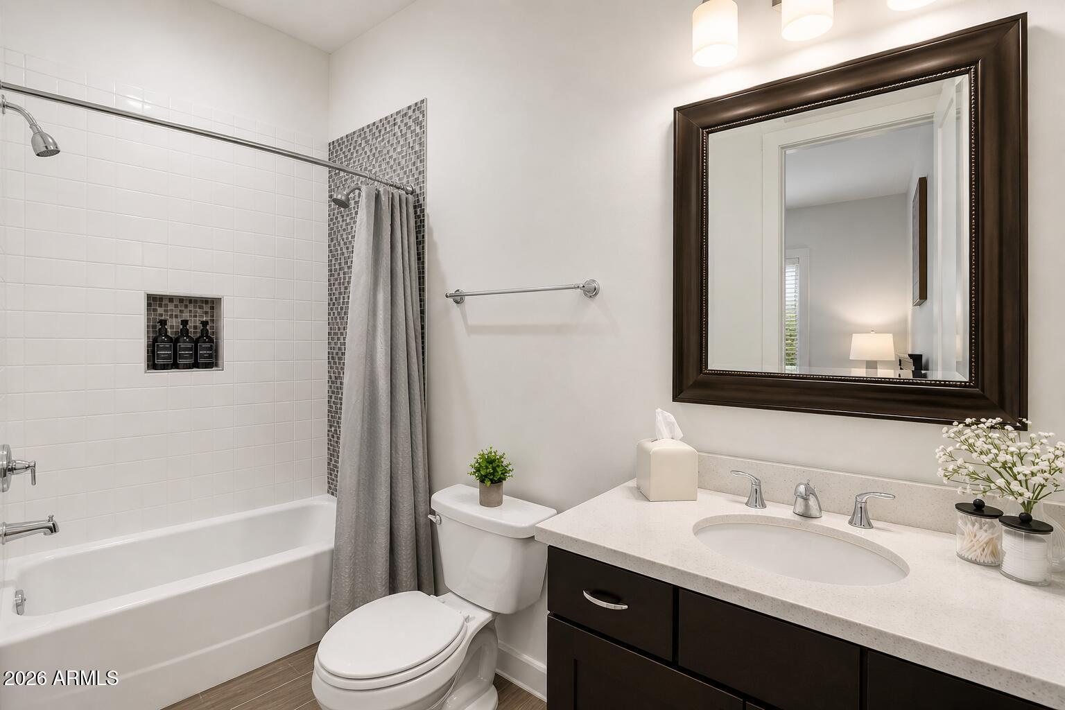 4201 East Cheery Lynn Road Phoenix, AZ 85018 - Photo 18 of 31 a bathroom with a granite countertop sink toilet a mirror a vanity and bathtub