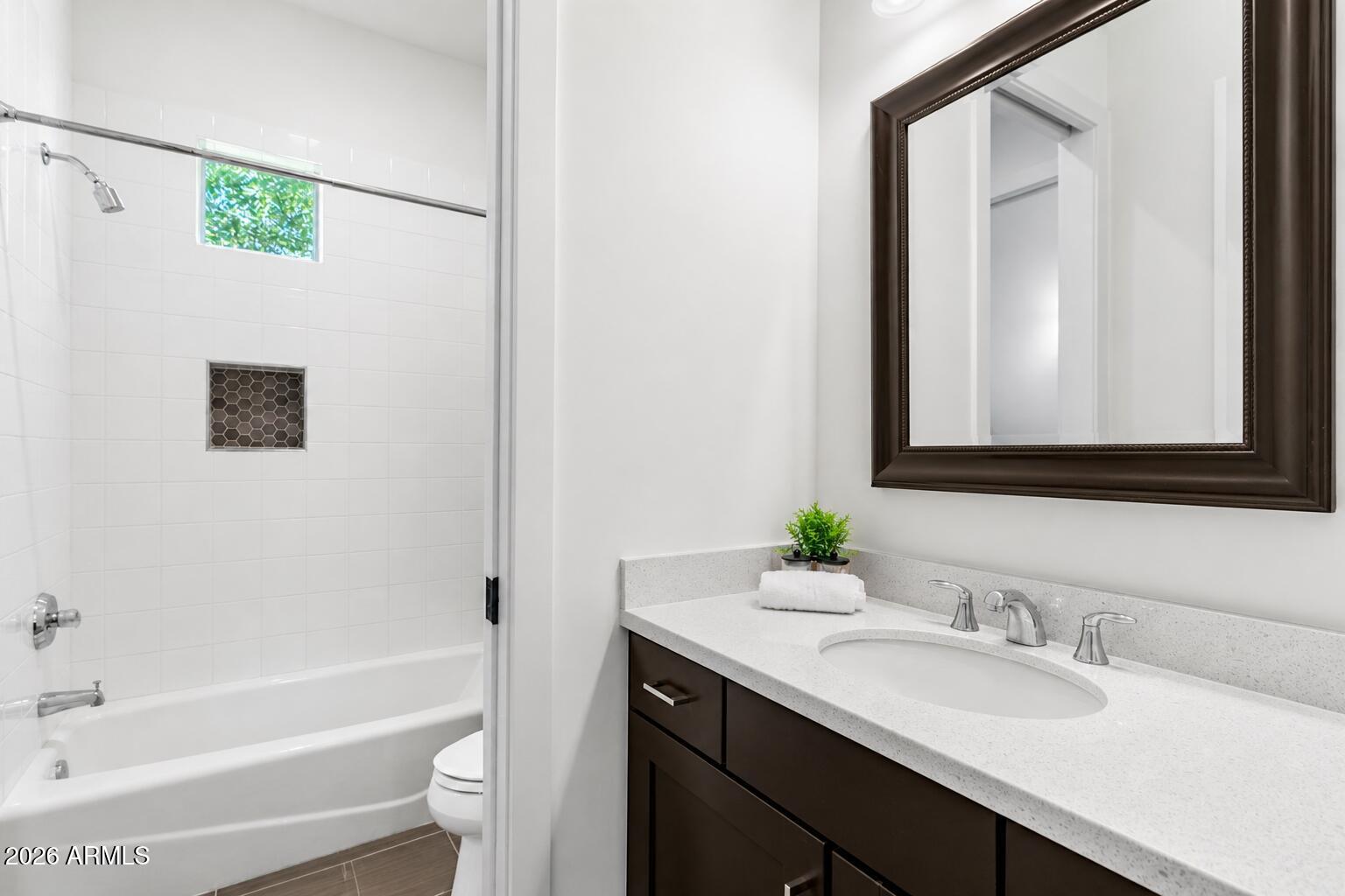 4201 East Cheery Lynn Road Phoenix, AZ 85018 - Photo 21 of 31 a bathroom with a granite countertop sink mirror and a bathtub