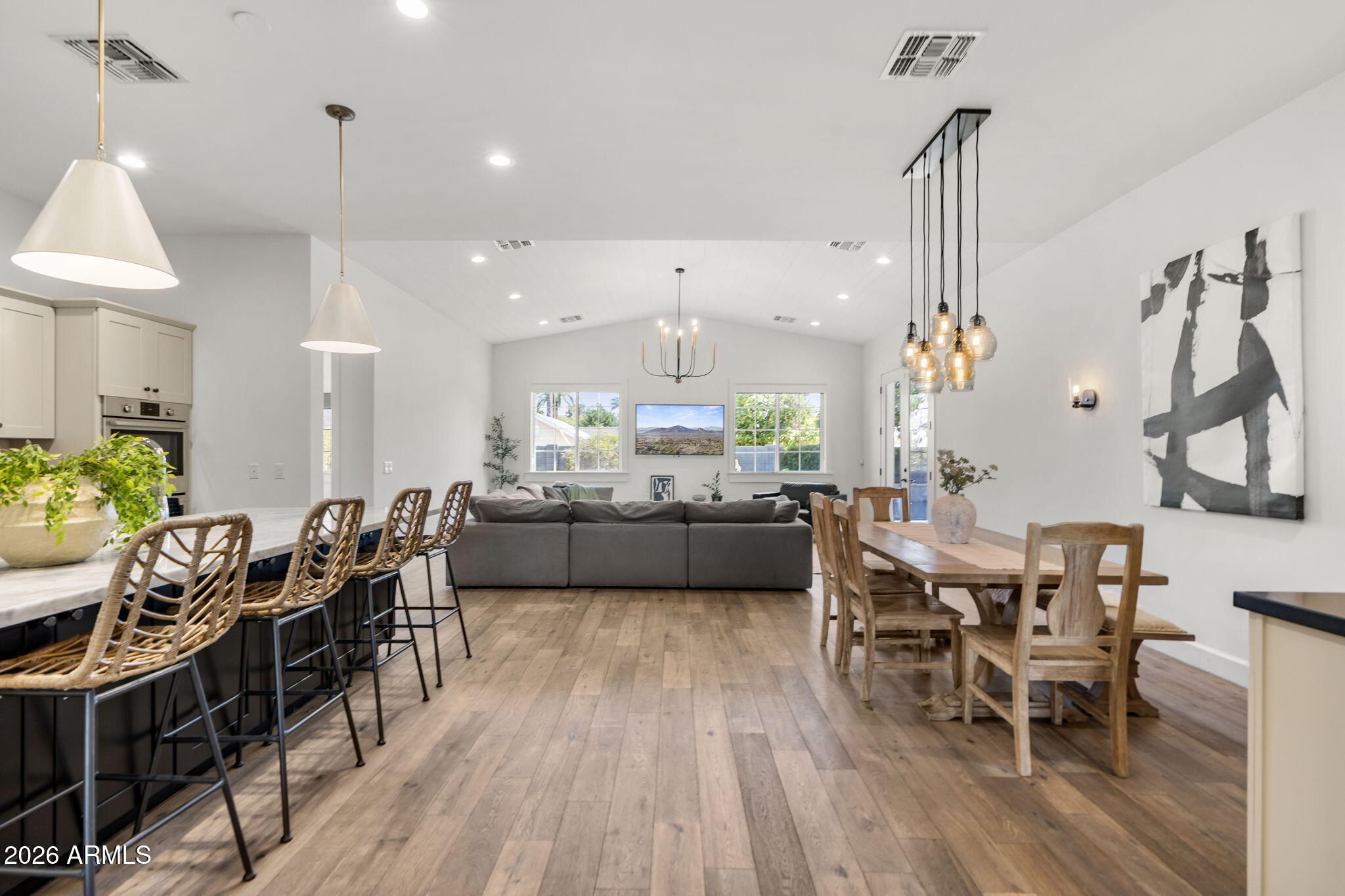 4201 East Cheery Lynn Road Phoenix, AZ 85018 - Photo 4 of 31 a view of a dining room and livingroom with furniture wooden floor a chandelier
