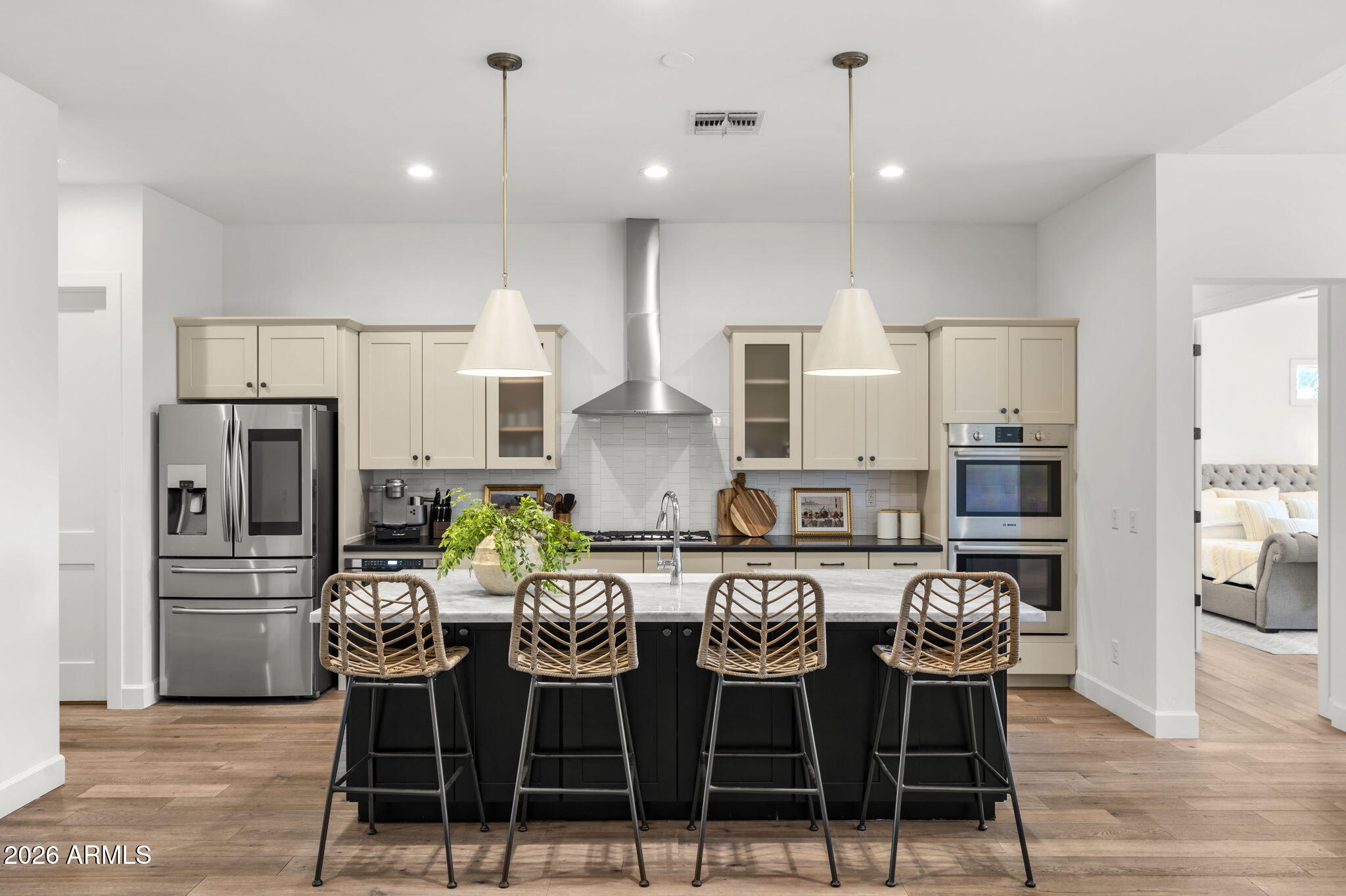4201 East Cheery Lynn Road Phoenix, AZ 85018 - Photo 7 of 31 a kitchen with stainless steel appliances kitchen island granite countertop a dining table chairs and a refrigerator