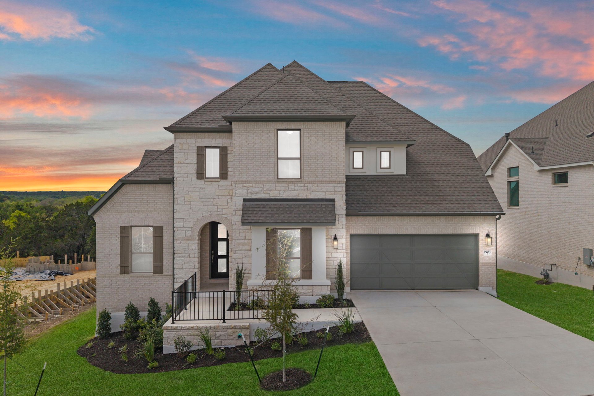 a front view of a house with a yard and garage