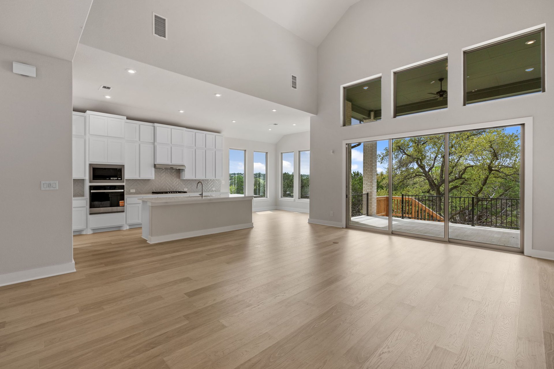 1908 Crimson Sunset Drive Georgetown, TX 78628 - Photo 20 of 40 a view of an empty room with kitchen view and a large window
