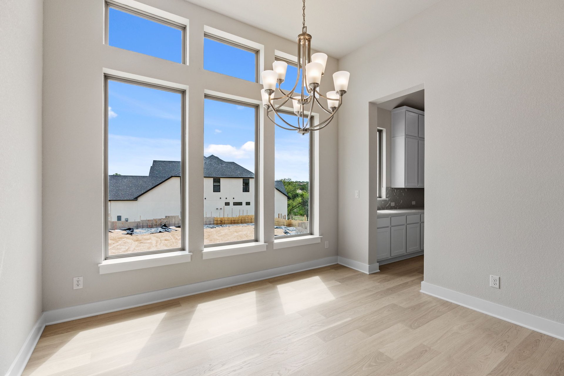 1908 Crimson Sunset Drive Georgetown, TX 78628 - Photo 24 of 40 a view of a big room with windows and chandelier