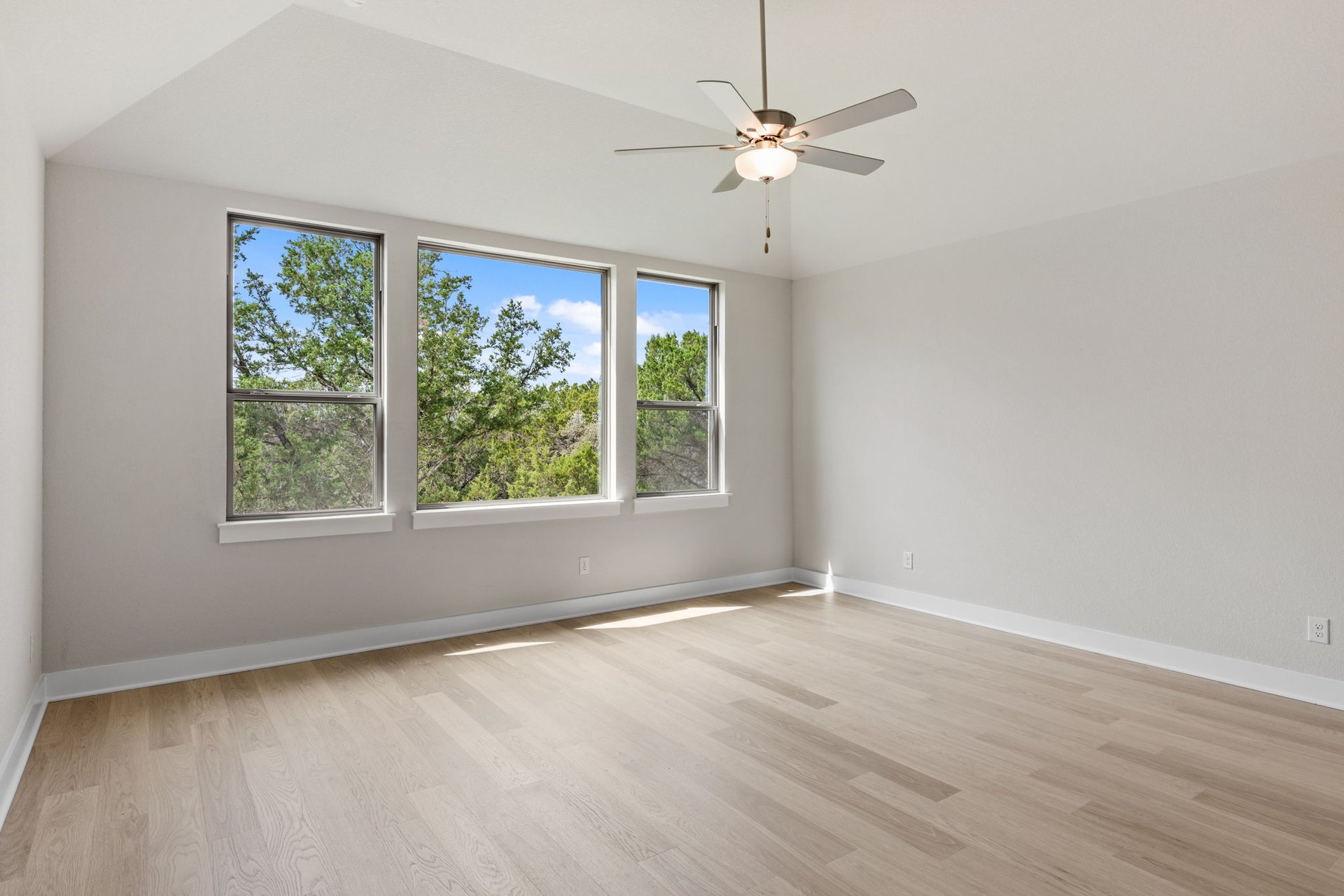 1908 Crimson Sunset Drive Georgetown, TX 78628 - Photo 26 of 40 an empty room with wooden floor fan and windows