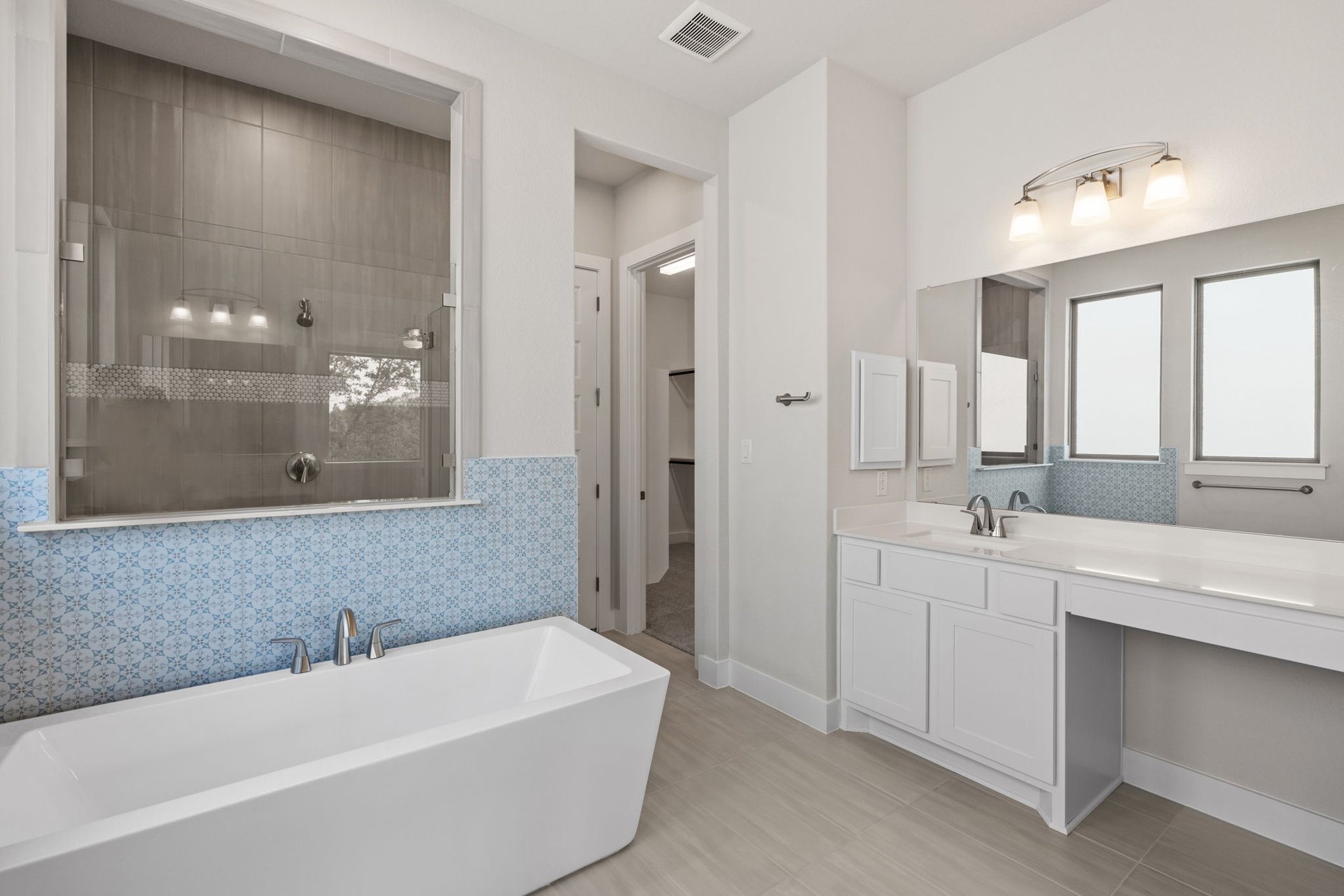 1908 Crimson Sunset Drive Georgetown, TX 78628 - Photo 29 of 40 a bathroom with a bathtub a double vanity sink and mirror
