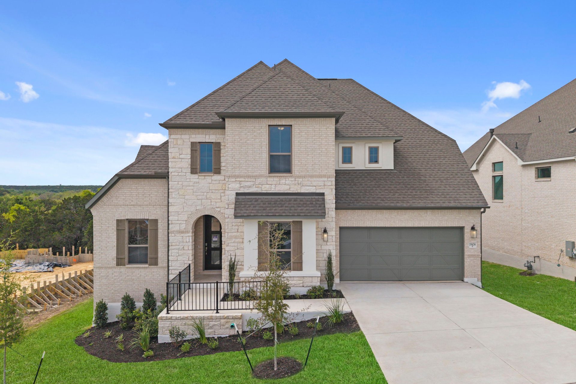 1908 Crimson Sunset Drive Georgetown, TX 78628 - Photo 3 of 40 a front view of a house with a yard and garage