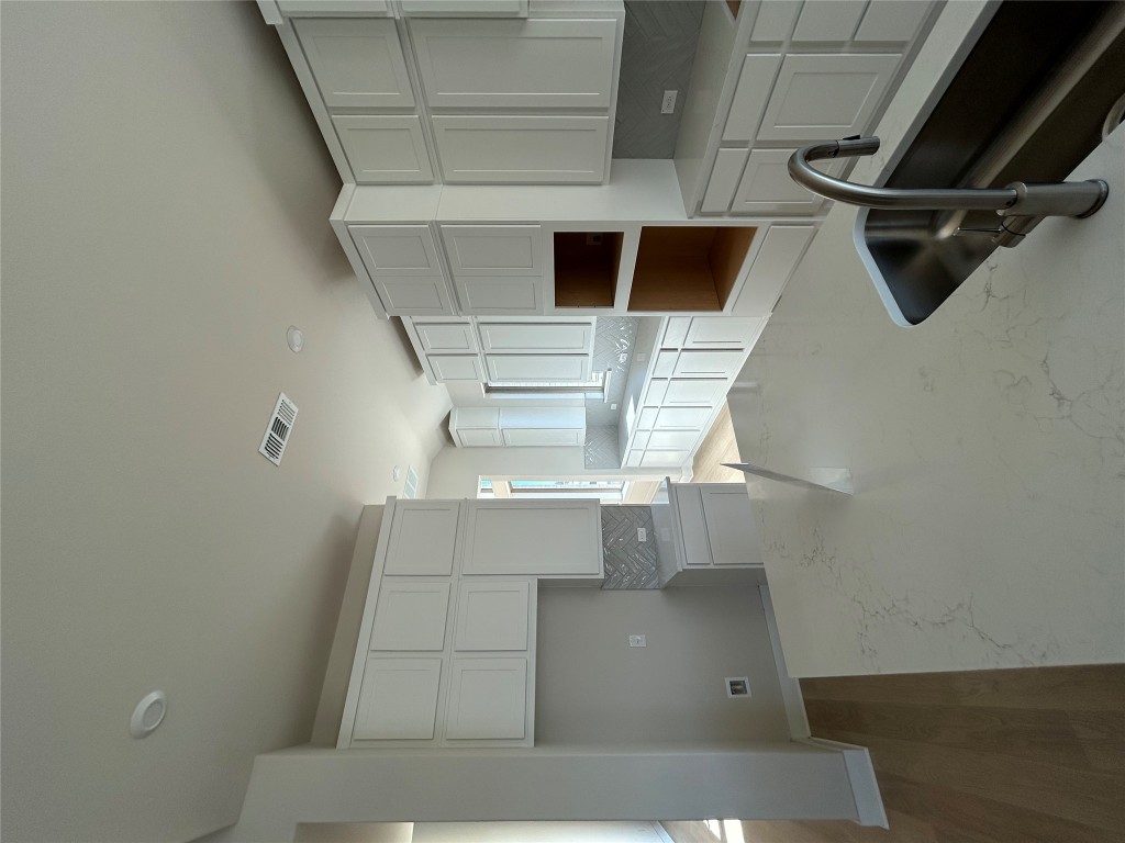 1908 Crimson Sunset Drive Georgetown, TX 78628 - Photo 3 of 22 a kitchen with stainless steel appliances wooden cabinets and a refrigerator
