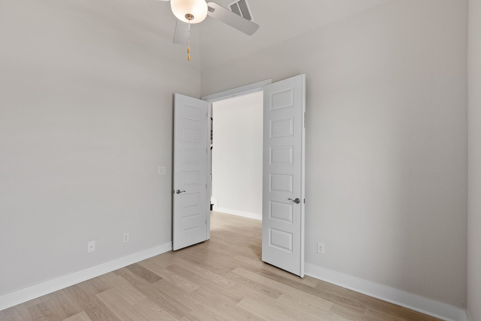 1908 Crimson Sunset Drive Georgetown, TX 78628 - Photo 36 of 40 an empty room with wooden floor and white walls