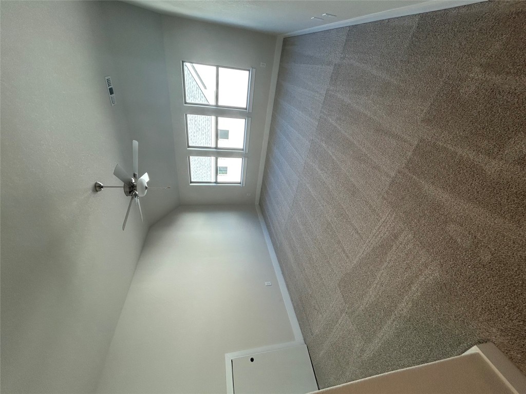 1908 Crimson Sunset Drive Georgetown, TX 78628 - Photo 10 of 22 an empty room with windows and ceiling fan