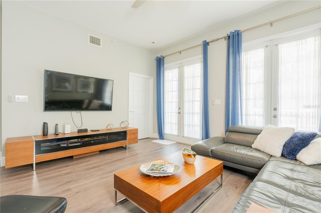 930 Spring Park Street, Unit 103 Kissimmee, FL 34747 - Photo 13 of 40 a living room with furniture and a flat screen tv
