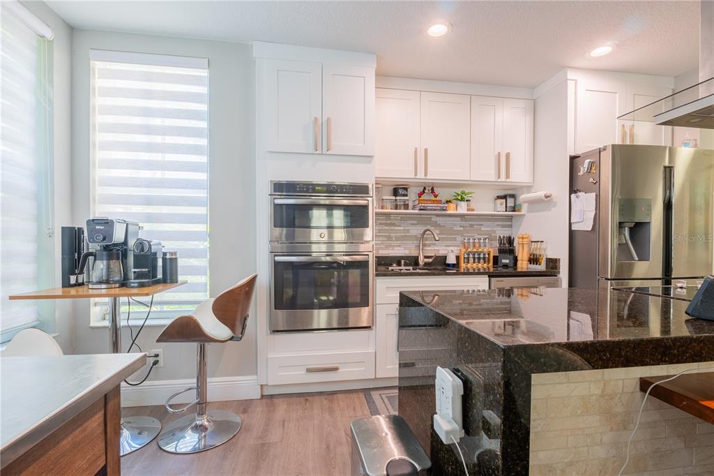 930 Spring Park Street, Unit 103 Kissimmee, FL 34747 - Photo 17 of 40 a kitchen with granite countertop stainless steel appliances a sink and counter space
