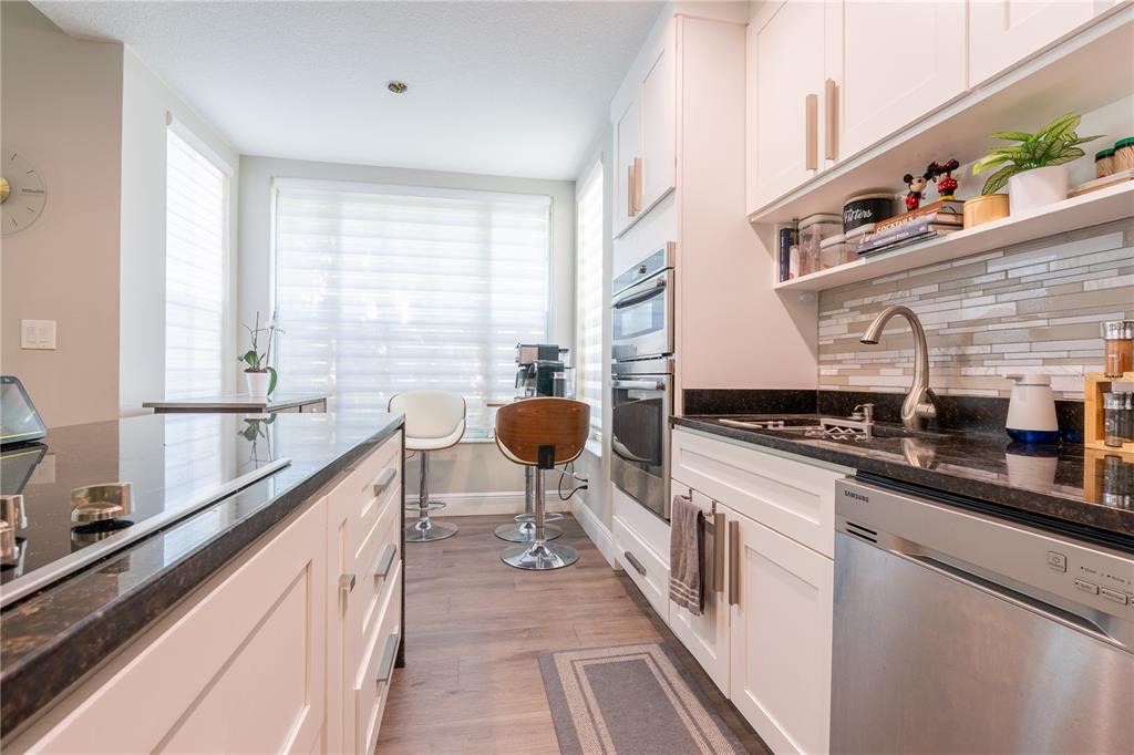 930 Spring Park Street, Unit 103 Kissimmee, FL 34747 - Photo 18 of 40 a kitchen with stainless steel appliances a sink and a stove