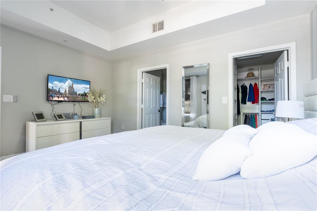 930 Spring Park Street, Unit 103 Kissimmee, FL 34747 - Photo 22 of 40 a bedroom with a bed and a large mirror