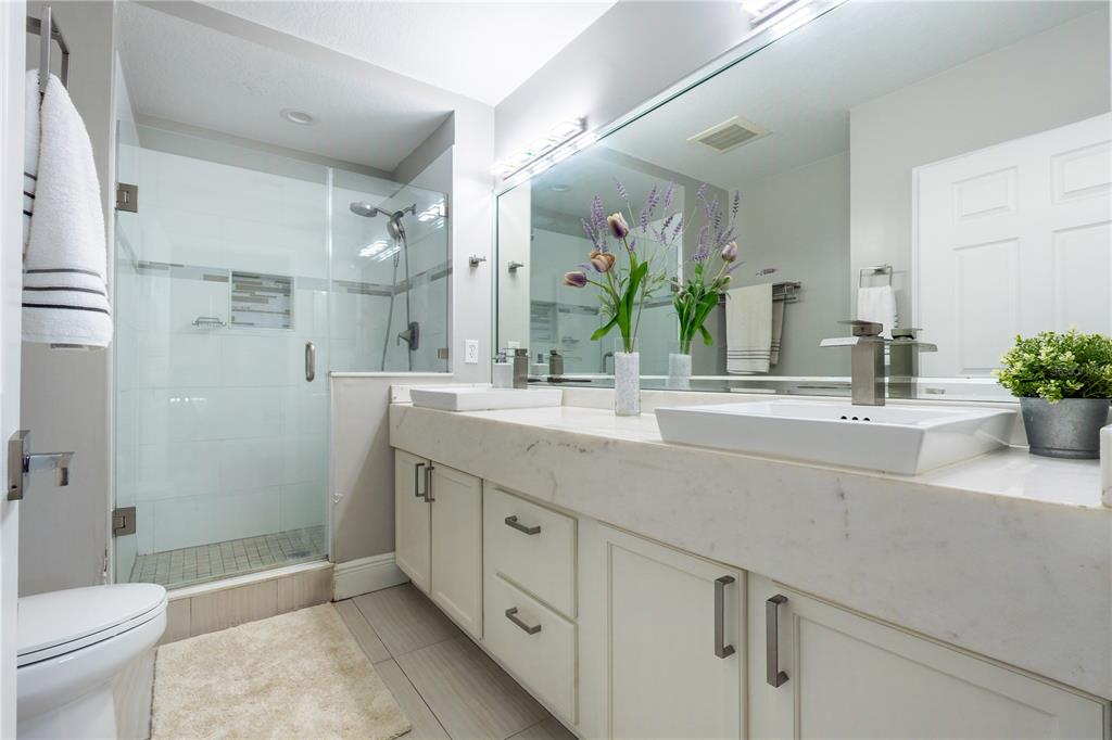 930 Spring Park Street, Unit 103 Kissimmee, FL 34747 - Photo 24 of 40 a bathroom with a sink a toilet and shower