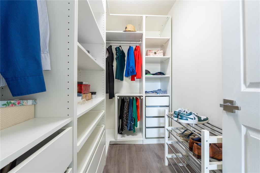 930 Spring Park Street, Unit 103 Kissimmee, FL 34747 - Photo 25 of 40 a view of walk in closet with clothes and shoes