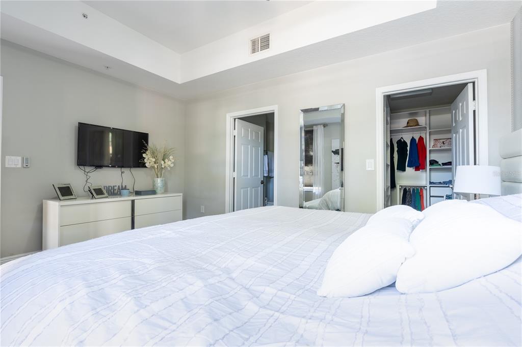 930 Spring Park Street, Unit 103 Kissimmee, FL 34747 - Photo 26 of 40 a bedroom with a bed and a flat screen tv in it