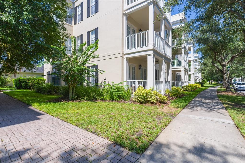 930 Spring Park Street, Unit 103 Kissimmee, FL 34747 - Photo 3 of 40 a view of a building with a yard
